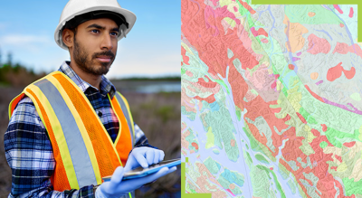 A field working standing in a swamp land holding a tablet