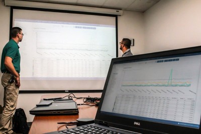 Mr. Bellino and Mr. Wade analyzing ArcMonitor data from the previous week.