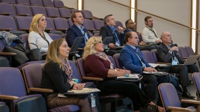 Nine judges from various industries sit in TCU auditorium seats watching the live presentations from students