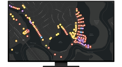 A desktop computer showing a map with bright activate resource locations indicated on a dark background
