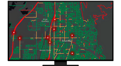 A computer displaying a map of green, yellow, and red lines with glowing red points 