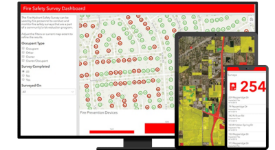 A graphic of a computer monitor displaying a fire safety dashboard, alongside a tablet and mobile phone showing coordinating data