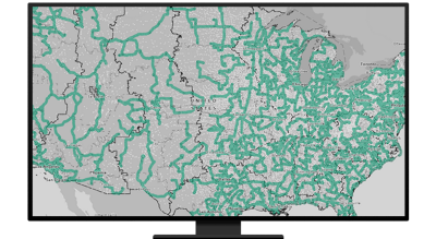 A graphic of a computer monitor displaying a road map of North America in grays and greens